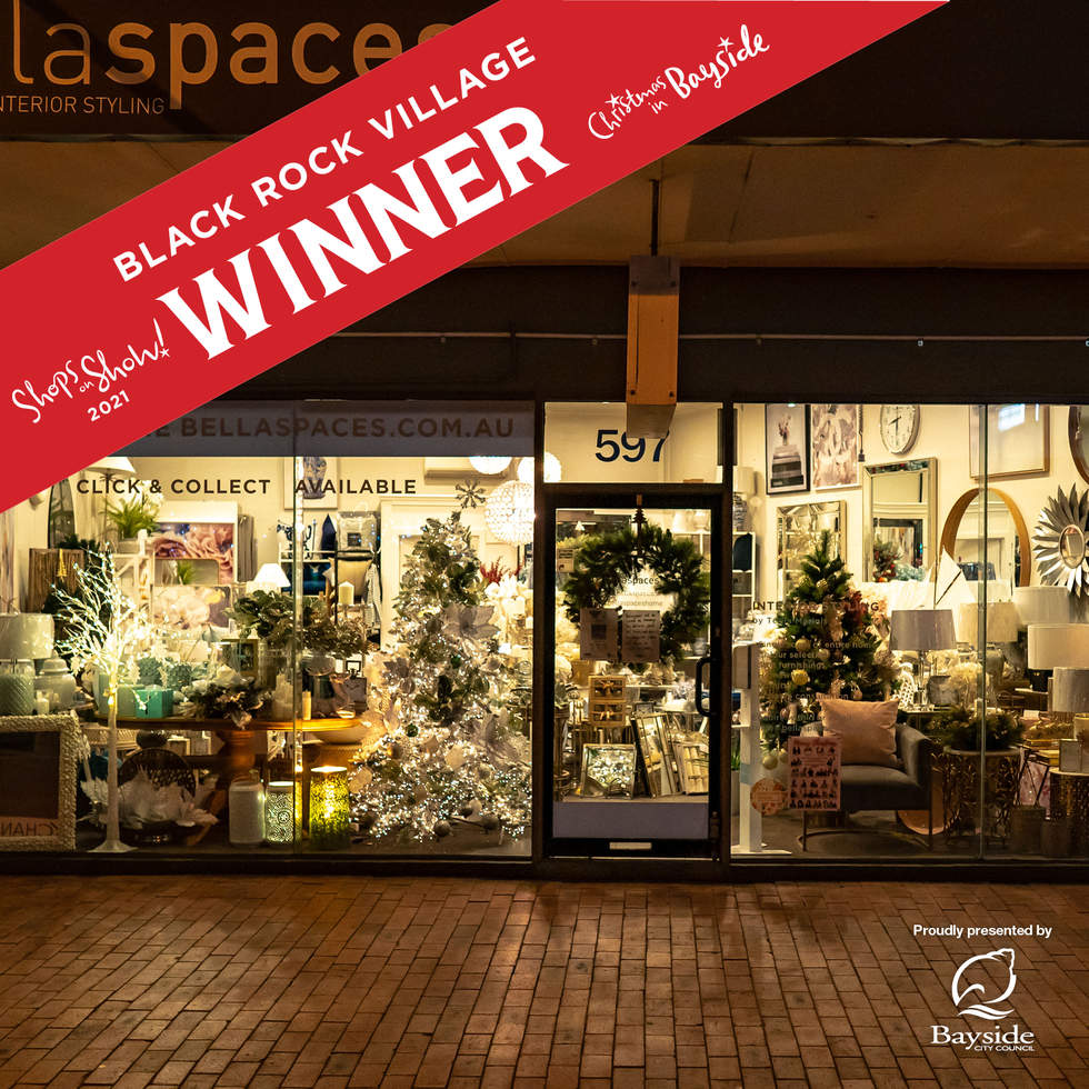 Black Rock Village Shops on Show winner. Glass shop front decorated with 2 Christmas trees and a wreath.