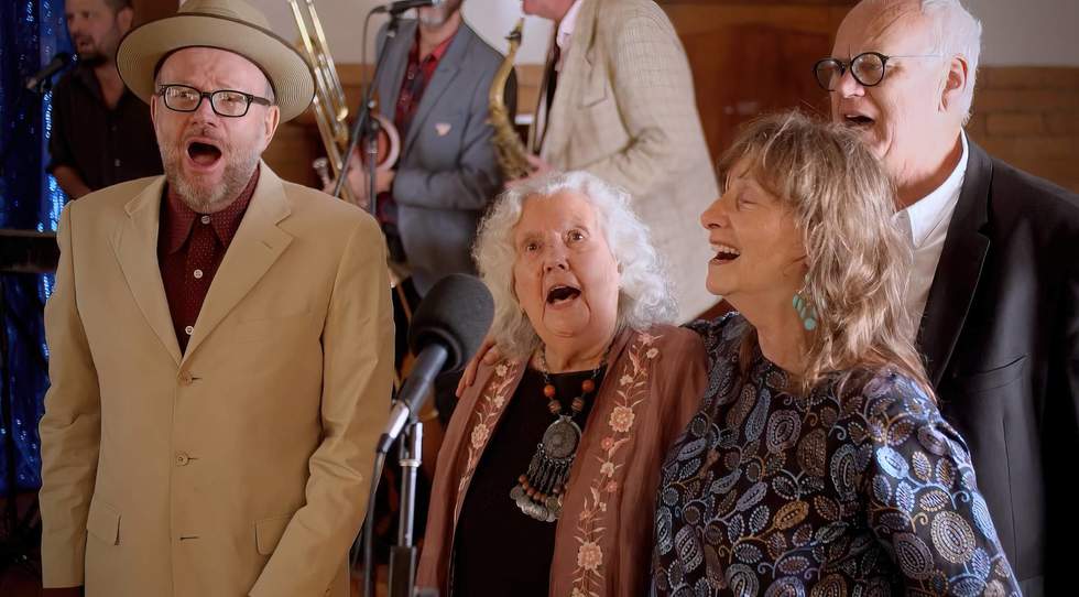Four older people singing 