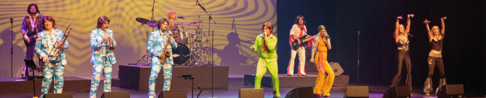 A 70s band performing on a stage
