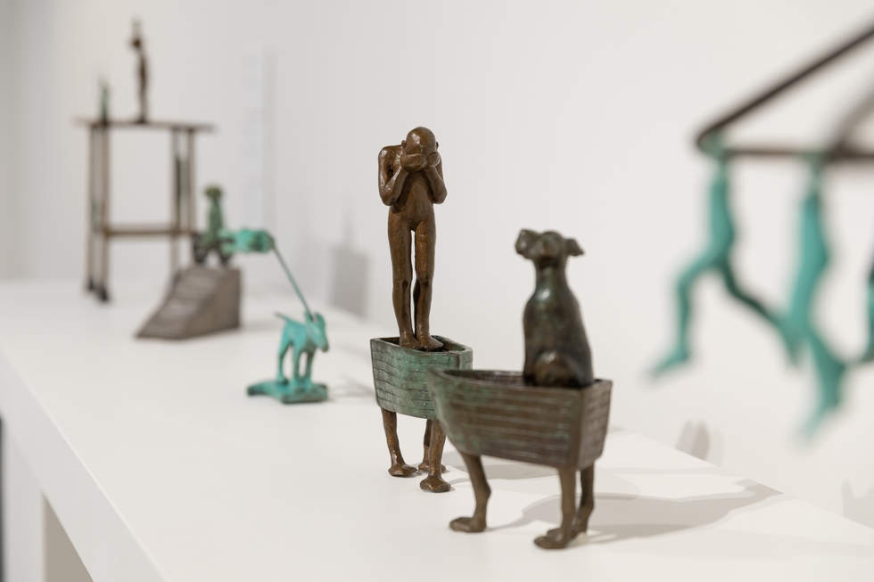 Installation of Anne Ross: Which Way Exhibition featuring various bronze sculptures of dogs