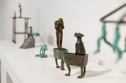 Installation of Anne Ross: Which Way Exhibition featuring various bronze sculptures of dogs