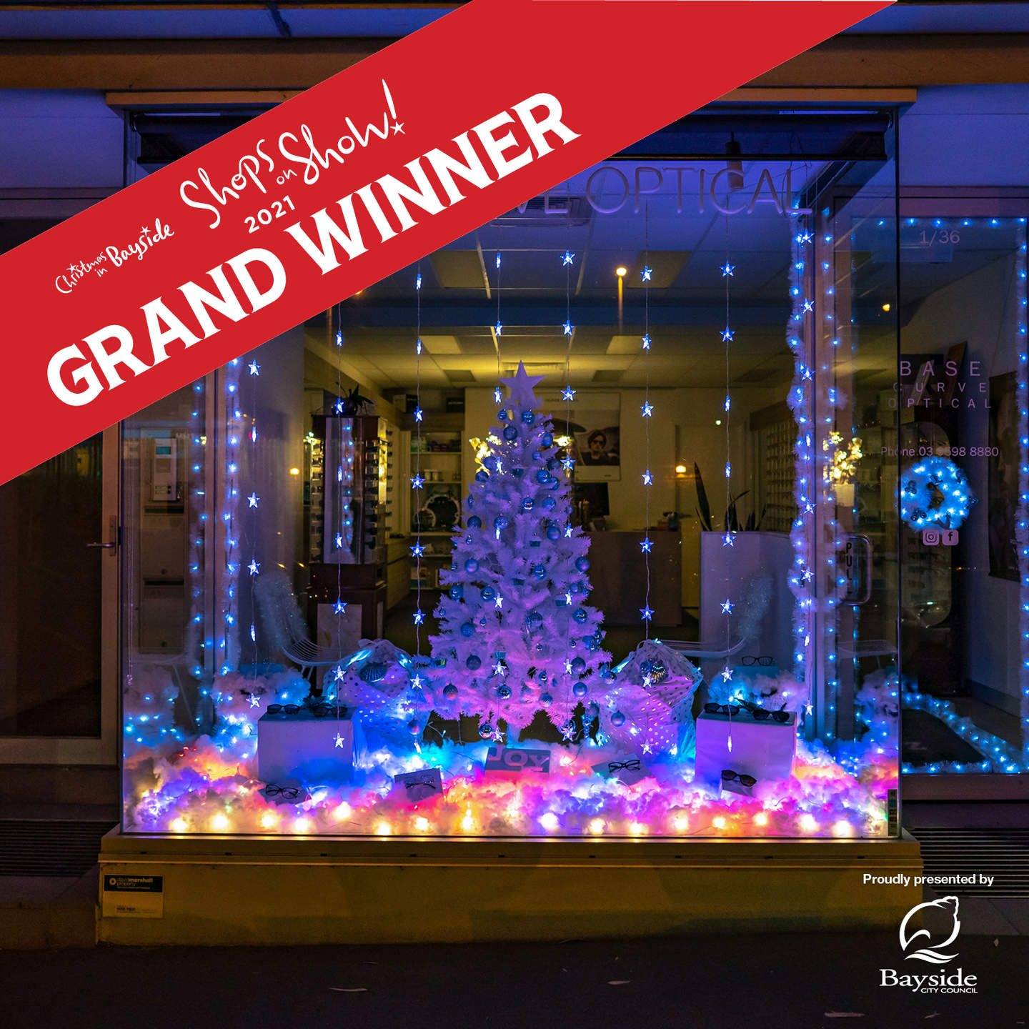 Shops on Show 2021 Grand Winner. Shop window illuminated by neon light decorated Christmas Tree.