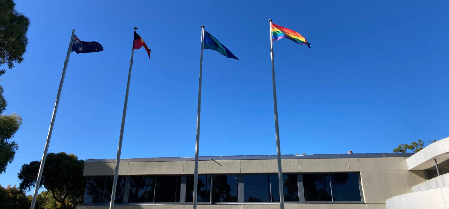 Australian, Indigenous, Torres Strait Islander and rainbow flags flying above Bayside City Council's corporate centre.