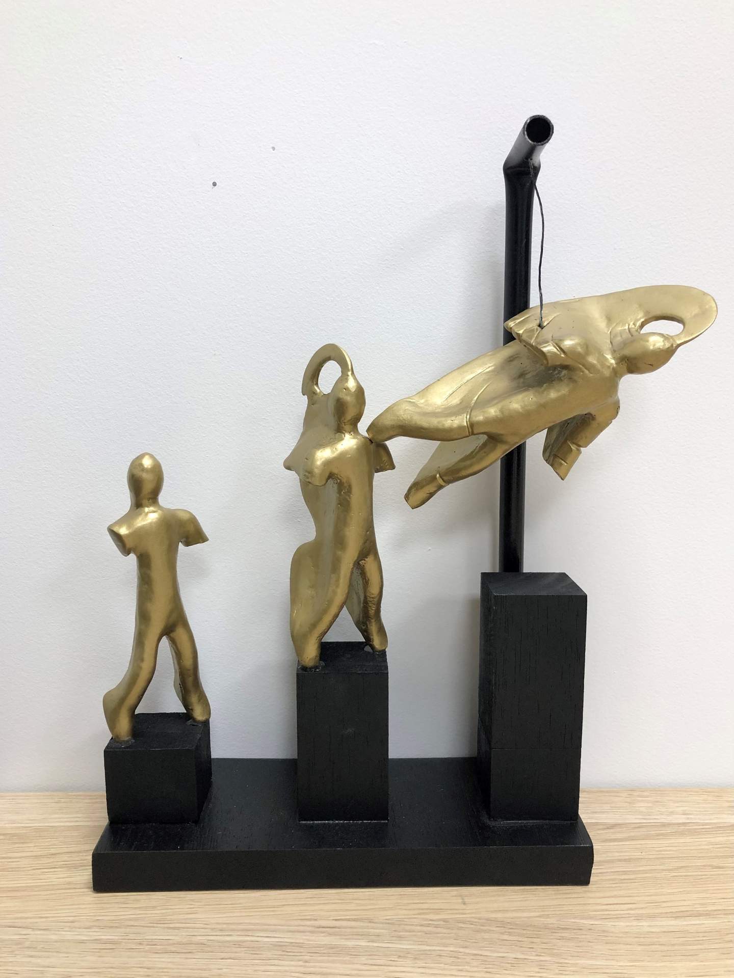 Black and gold scuplture of man-like three figurines. Maxim Blokker. Young People of Bayside Art Exhibition winner. 