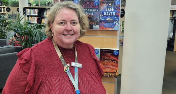 Friendly Librarian Karen standing in front of a bookshelf at Beaumaris Library
