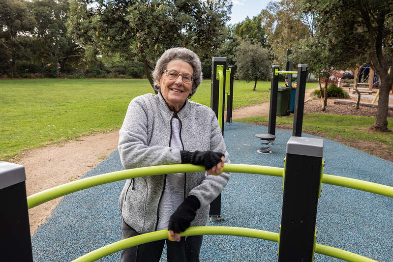 Senior person using all access equipment at the park