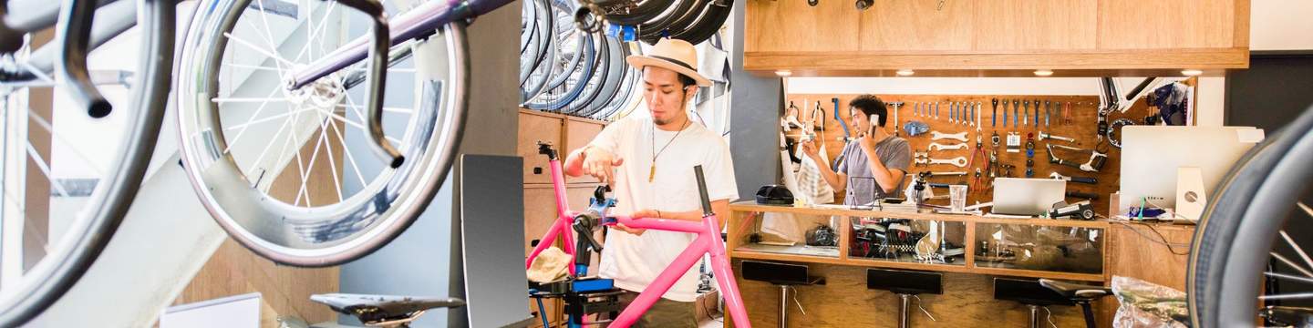 A man fixing a bike in a workshop 