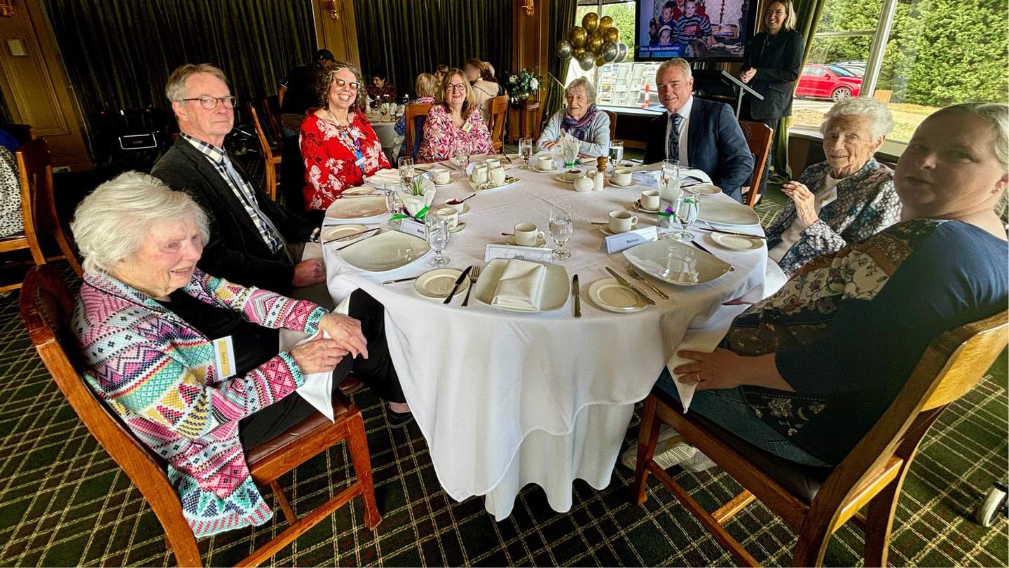 People sitting at a nicely presented table in restaurant. 