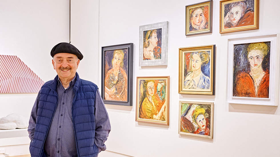 Norman Rosenblatt standing in Bayside Gallery in front of his collection