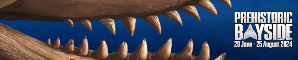 A blue graphic with open jaws of a prehistoric animal 