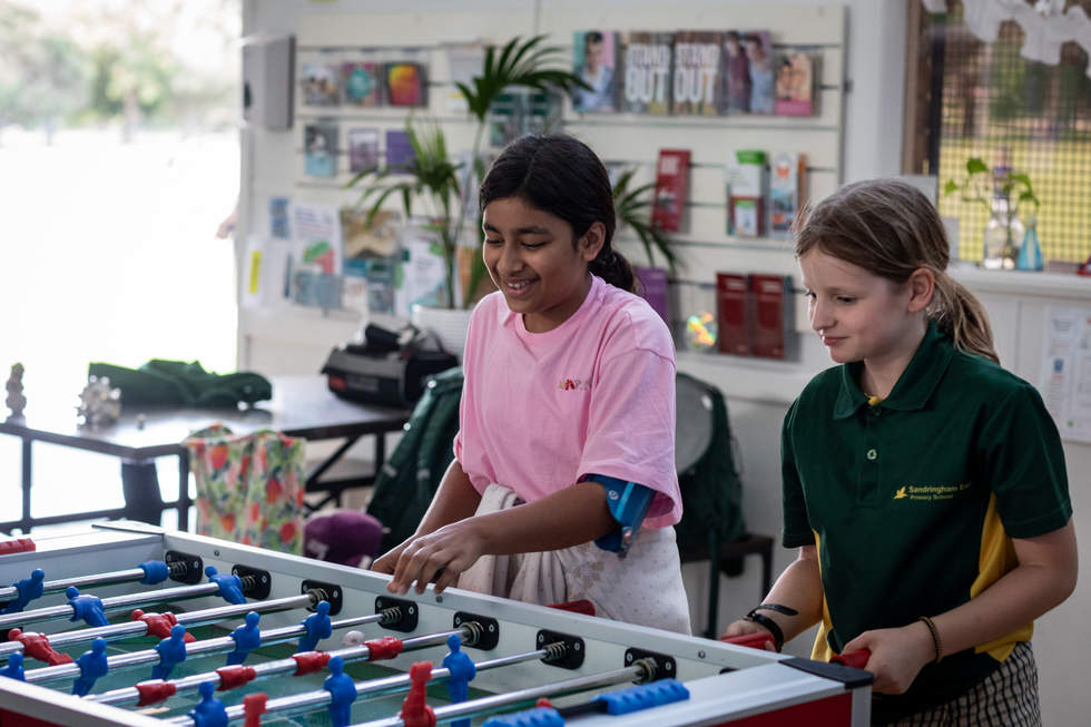Two young women playing foosball