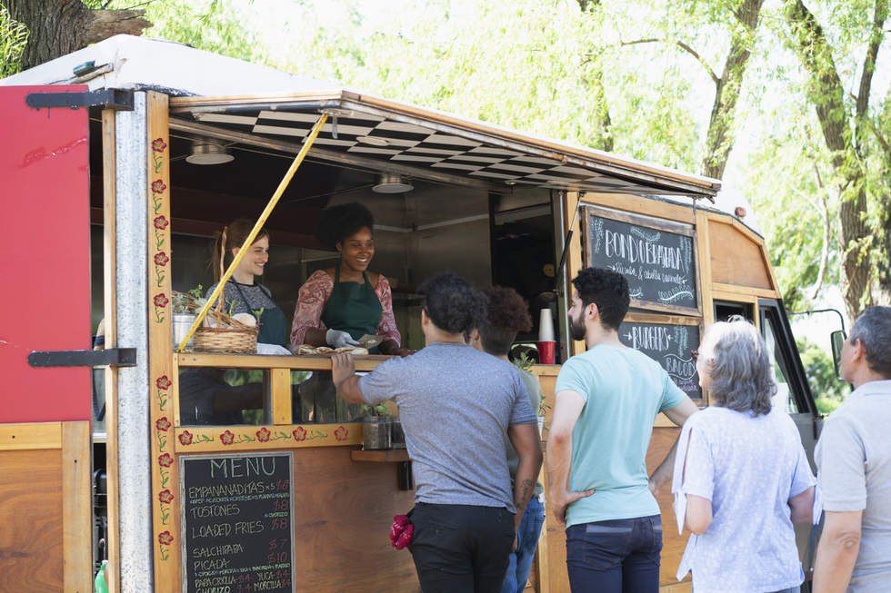 People standing in front of a food truck